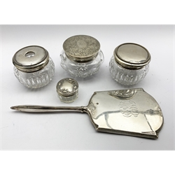 American cut glass dressing table jar with sterling silver cover, matching hair tidy, both with bead edge decoration by Gorham, silver backed mirror by Webster Co. small glass and silver jar and a large glass jar with engraved silver cover by Kerr & Co 