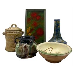 Bretby ware three handled jar with dripped glaze decoration, 'Candy Box Top' baked lacquered panel in standing frame, studio pottery bowl with painted fish interior together with bottle vase with mottled glaze and vase with cover marked 'JL' to base max H24cm (5)