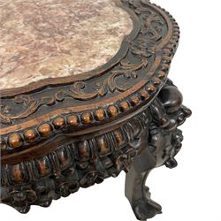Small late 19th to early 20th century carved hardwood jardinière or urn stand, shaped rose marble top enclosed by bead and scrolling foliate carved surround, the frieze rails carved and pierced with flowerheads, on dragon mask carved cabriole supports with ball and claw feet