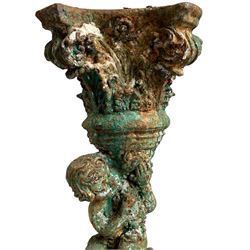 Victorian cast iron pedestal, Composite capital held aloft by sitting putto, the pedestal base draped in fruit and foliage, stepped and moulded circular base
