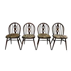 Set of four Ercol dining chairs, the hooped cresting rail over pierced splat and spindle back, raised on turned supports united by a stretcher  