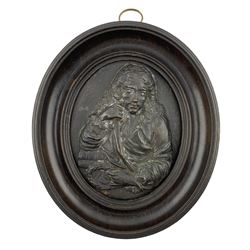 19th century oval patinated copper portrait plaque, modelled as a 17th century Scholar, within an ebonised wooden frame, 15cm x 13cm 