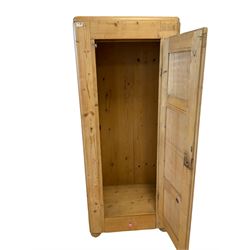 20th century single pine wardrobe, fitted with one hanging rail and drawer, raised on turned bun feet 