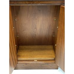 Regency style walnut breakfront bookcase, boxwood strung top over double cupboard enclosing two adjustable shelves and two banks of four graduated drawers, raised on skirted base W113cm, D32cm, H92cm