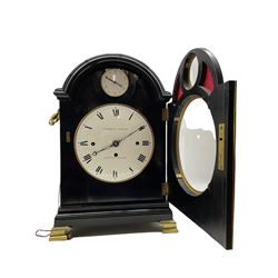 Early 19th century ebonised bracket clock by Desbois & Wheeler of Gray's Inn Passage, London, in a pad topped break arch case with a full-length door with silk backed fretted spandrels, case on a moulded plinth raised on four bracket feet, cast brass handles and sound frets to the sides, with an enclosed circular convex enamel dial with Roman numerals, minute markers and finely pierced steel moon hands, corresponding enamel pendulum adjustment dial graduated in five minute increments, three train fusee movement with a  recoil anchor escapement chiming the quarters on eight-bells and hours on one, with pull repeat and pendulum lock, dial and movement backplate inscribed Desbois & Wheeler. With pendulum, winding key and two case keys