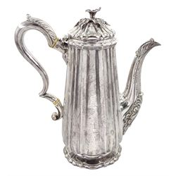 Victorian silver coffee pot of fluted tapering design, the domed cover with a floral lift, leaf capped handle and spout and on a spreading foot, engraved with a crest H24cm London 1844 Maker Richard Sibley retailed by Makepeace, London 28.7oz Provenance: 2nd Baron Feversham