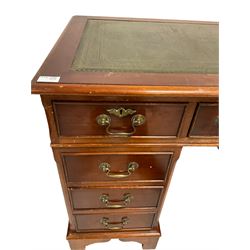 Georgian design yew wood desk, the inset top over fitted with nine drawers, raised on bracket supports 