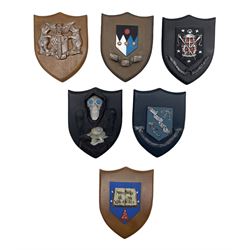 Set of six Clarecraft Terry Pratchett's Discworld shield shaped wall plaques comprising 'Seamstresses Guild', 'Fools Guild', 'The Musicians Guild', 'The Ankh Morpork Coat of Arms' and two others (6)