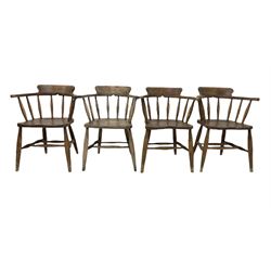 Set of nine early 20th century smokers chairs, the hooped and spindle back over elm seat, raised on turned supports, united by stretcher 