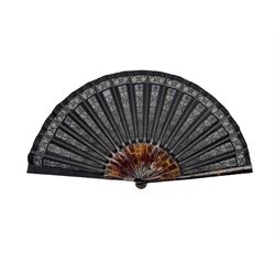19th/ early 20th century Tortoiseshell fan, the black gauze leaf embroidered with silver sequins and metal thread tambour stitch, in vertical panels, with pique work tortoiseshell sticks and guards (guard L21cm)