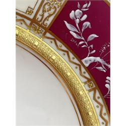Mid 20th century Minton plate decorated with three pâte-sur-pâte panels of birds on a cerise ground within raised gilt borders, signed L. Wood and numbered H5103, retailed by T. Goode & Co. Ltd, D20cm, together with another Minton plate with heavily gilded border (2)