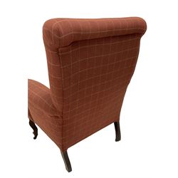 Edwardian armchair upholstered in later fabric, terminating in ceramic castors 