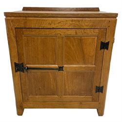 Rabbitman - oak bedside or lamp cupboard, adzed rectangular top over single panelled door with wrought metal latch and hinges, carved Rabbit signature, the interior fitted with divisions, by Peter Heap, Wetwang