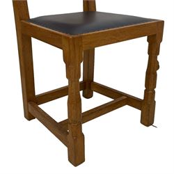 Mouseman - set six oak dining chairs, adzed panelled back, upholstered in navy blue leather with studded band, the octagonal front supports carved with mouse signatures, by the workshop of Robert Thompson, Kilburn
