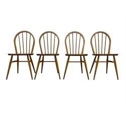 Ercol - set four elm and beech 'Windsor Dining Chairs', hoop stick back over splayed and tapered supports united by H-stretcher