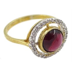 Silver-gilt cabochon garnet ring with cubic zirconia halo surround, stamped Sil