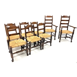  Set eight (6+2) oak rail back country chairs, with rush seats raised on turned front supports united by stretchers, W62cm  
