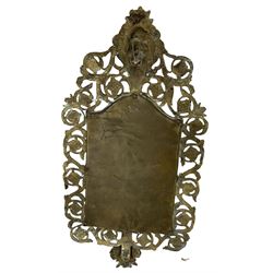 19th century brass girandole mirror, cast with the mask of Dionysus and bordered by pierced scrollwork, issuing two acanthus moulded branches and engraved sconces, with bevelled rectangular arched plate, H44cm, together with a pair of similar rectangular wall mirrors, each with mask crestings and pierced scrollwork borders, H48cm x W25cm (3)
