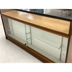 20th century teak haberdashery shop display cabinet, glazed display top, one side fitted with sixteen drawers, the other side with two sliding glass doors enclosing display shelves, W182cm, H94cm, D52cm