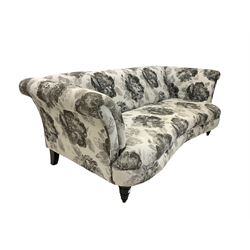 Three seat serpentine sofa, upholstered in natural floral fabric, raised on turned supports 