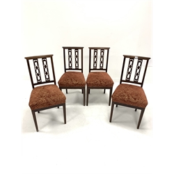 Set four Edwardian mahogany dining chairs, with inlaid cresting rail and pierced splats over red floral upholstered and overstuffed seats, raised on square tapered supports, W45cm
