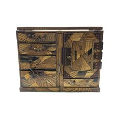 Early 20th century Japanese parquetry Tansu or travelling writing desk, the removable top flanked by four drawers and cupboard, strapwork hinges and patinated metal handles, L69cm, H27cm, D26cm 