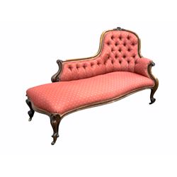 Victorian rosewood chaise longue, the shaped crest rail with floral carved pediment and scrolled terminals, button back and seat upholstered in patterned pale red silk, raised on scrolled cabriole supports terminating in castors, L160cm