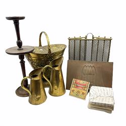 Victorian embossed brass coal scuttle, of helmet form with loop handle and hinged top H53cm, brass fire guard, an Art Nouveau style cast iron fire hood, set of fire place tiles, two brass jugs and a smokers stand 