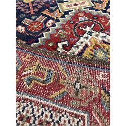 Pair of Persian ground rugs, the triple medallion with navy field enclosed by red border 205 x 97