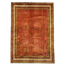 Persian Arrak red ground rug, the field decorated all-over with repeating Boteh motifs, multi-band border with geometric designs