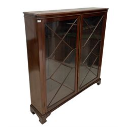 Victorian mahogany gun cabinet, two glazed doors of astragal design opening to reveal fifteen gun stands, raised on bracket supports 
