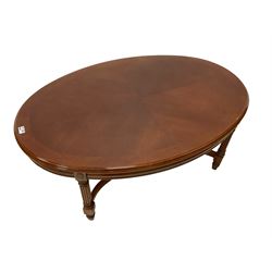 Mahogany coffee table, oval moulded top on square reeded supports joined by curved x-framed stretchers