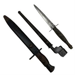British No.5 Jungle Carbine bayonet by Wilkinson Sword Co. with fullered blade and two piece wooden grip in scabbard overall length 32cm, a commando knife and a No.4 cruciform bayonet (3)