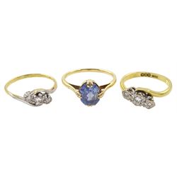 Two early 20th century 18ct gold three stone diamond rings and a 15ct gold single blue stone ring 
