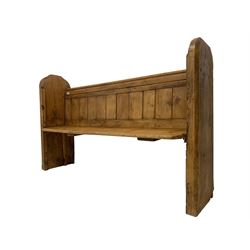 19th century waxed pine pew or bench, plank back with moulded cresting rails, raised on shaped and chamfered end supports