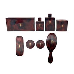 20th century imitation tortoiseshell lacquered dressing table set with eight jars, boxes and brushes inlaid with gilt monogram for Feversham 