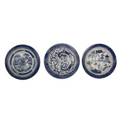 18th century/ 19th century Chinese Export blue and white plate, centrally painted with three dragons chasing the flaming pearl, amidst clouds, within a foliate border D20.5cm together with two further Chinese blue and white plates (3)