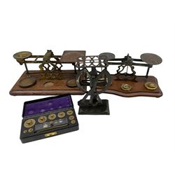 Set of Edwardian brass Postal Scales 'Inland Letter Post' on oak base, L29cm, another similar set with brass weights, set of 'Foreign Letter' scales and a 1940's cased set of weights in bakelite case (4)