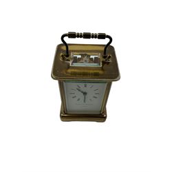 Mathew Norman - Swiss-20th century 8-day carriage clock in a brass corniche case, with a jewelled lever platform escapement, enamel dial with Roman numerals, minute track and steel moon hands, dial inscribed Matthew Norman, London. With key.