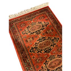 Persian pale lilac ground rug, decorated with repeating geometric lozenge pattern (172cm x 94cm); Persian design red ground rug, decorated with four stylised medallions (160cm x 83cm); Persian red and ivory ground rug (157cm x 96cm); and a Persian pale grey ground rug (187cm x 128cm) (4)