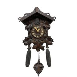An early 19th century German Black Forest cuckoo clock in a carved oak case, 30-hour chain driven movement with wooden plates, brass wheels and trundle pinions, countwheel striking mechanism sounding the cuckoo on twin bellows and striking on a coiled steel gong, dial with original  Roman numerals and hands.
With chains, weights and pendulum (damaged).




