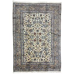 Persian ivory ground rug, the field decorated with scrolling foliate branches and palmette motifs, surrounded by a guarded border with indigo detailing and repeating interlacing stylised plant motifs