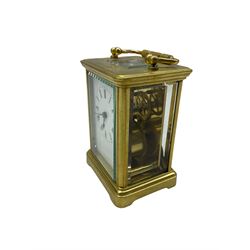 A late 19th century French Corniche carriage clock with four bevelled glass panels and a rectangular panel to the top, eight-day spring driven timepiece movement with a replacement lever escapement, balance wheel and timing screws, with a white enamel dial, Roman numerals, minute markers and steel spade hands. With Key.
