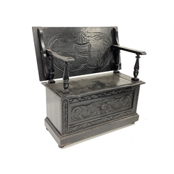 Early 20th century dark oak monks bench, the top carved with scrolled acanthus leaves enclosing lozenge, hinged storage compartment in the seat, raised on compressed bun supports, W92cm