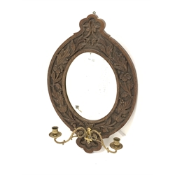 20th century oak framed wall mirror, with floral carved frame enclosing bevelled plate, and two brass sconces, 46cm x 71cm