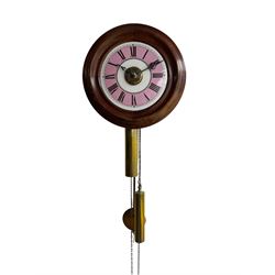 A late 19th century German “postman's” alarm clock with a 11” wooden bezel and 7” dial with contrasting pink chapter ring and black Roman numerals, with pierced steel hands and a brass alarm setting disc, chain driven 30hr movement with wooden plates and brass wheels and lantern pinions, alarm sounding on a brass bell.
With two weights and pendulum.




