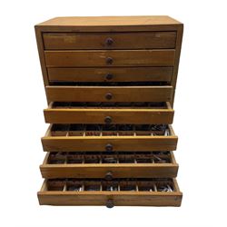 An eight drawer printers chest containing a quantity of metal stamps/ matrices, H32cm, W31.5cm, D20.5cm