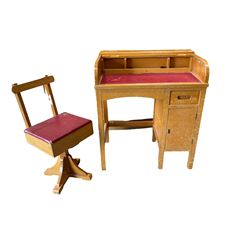 Hardwood children's writing desk, the roll top enclosing inkwells, pigeon holes and faux leather inset, over one drawer and one cupboard, together with swivel chair with hinged lifting seat 