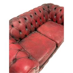 Two seat Chesterfield sofa upholstered in buttoned red leather