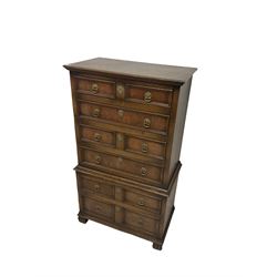 18th century design oak chest on chest, fitted with two short and five long panelled oak lined drawers, raised on lobed supports 